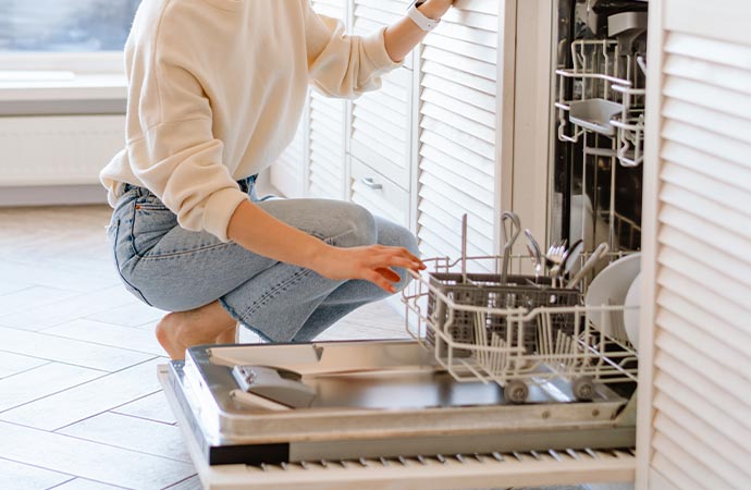 Professional worker cleaning dishwasher